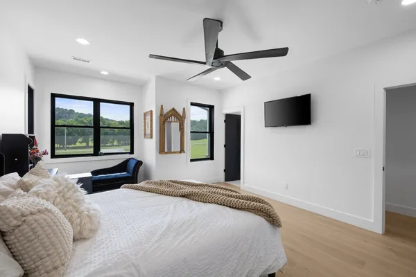 a front view of a house with a garden and yard