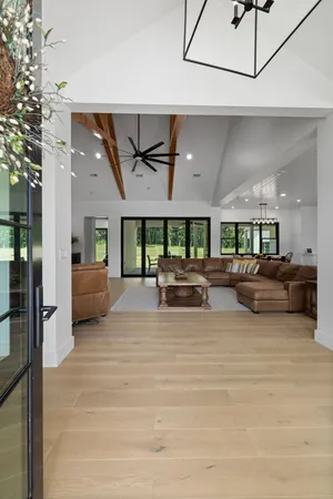 an empty room with windows and couches