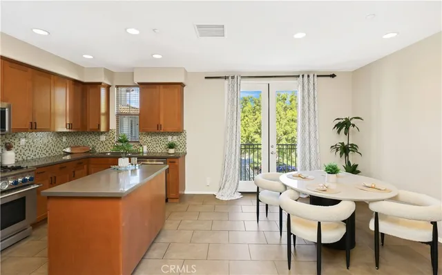 a kitchen with a table chairs stove and kitchen island