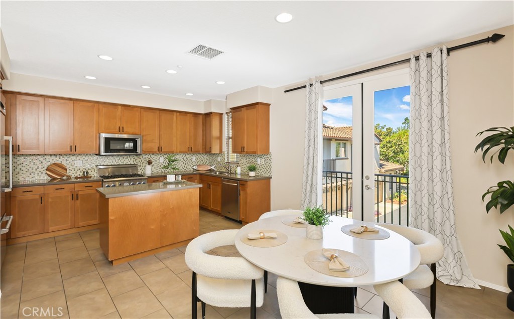 23 Crosspointe Irvine, CA 92618 - Photo 13 of 47 a kitchen with granite countertop sink cabinets and stainless steel appliances