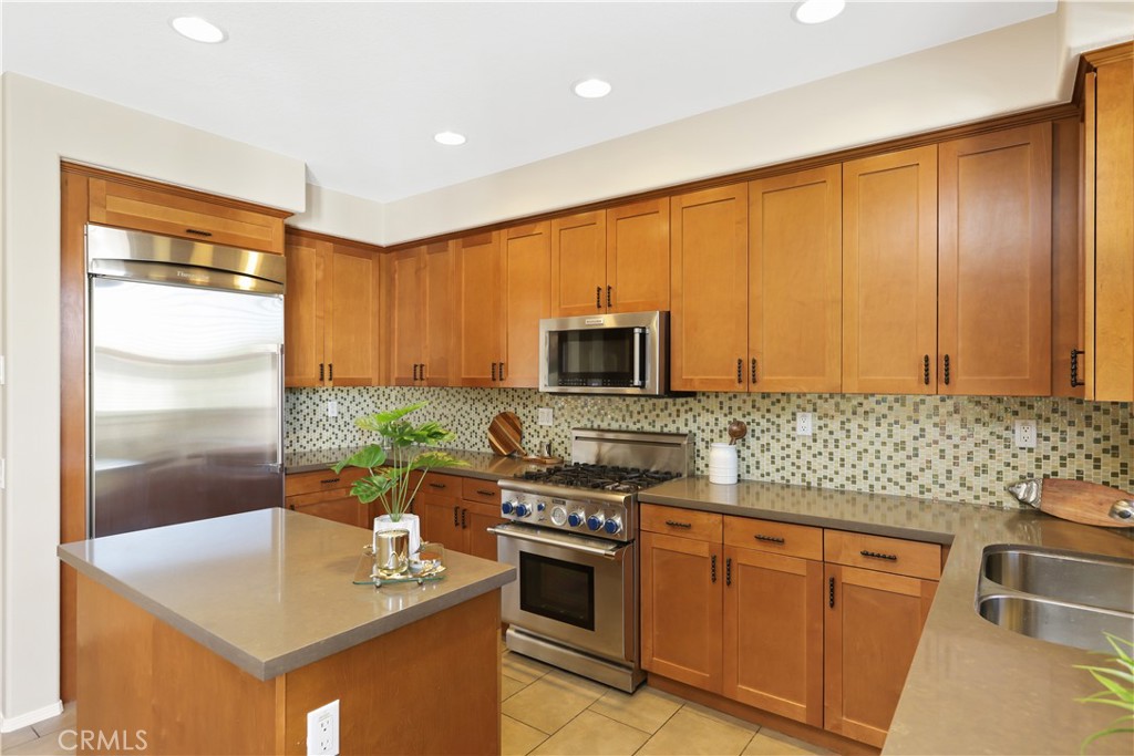 23 Crosspointe Irvine, CA 92618 - Photo 2 of 47 a kitchen with stainless steel appliances granite countertop a stove a sink and a microwave