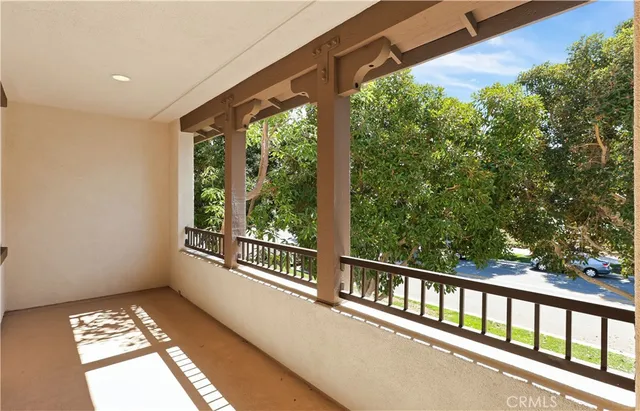 a view of an empty room with closet and a window