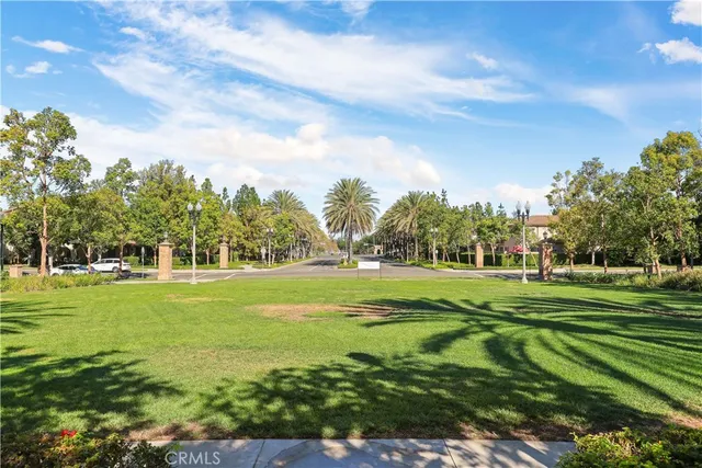 a view of a tennis ground with large trees