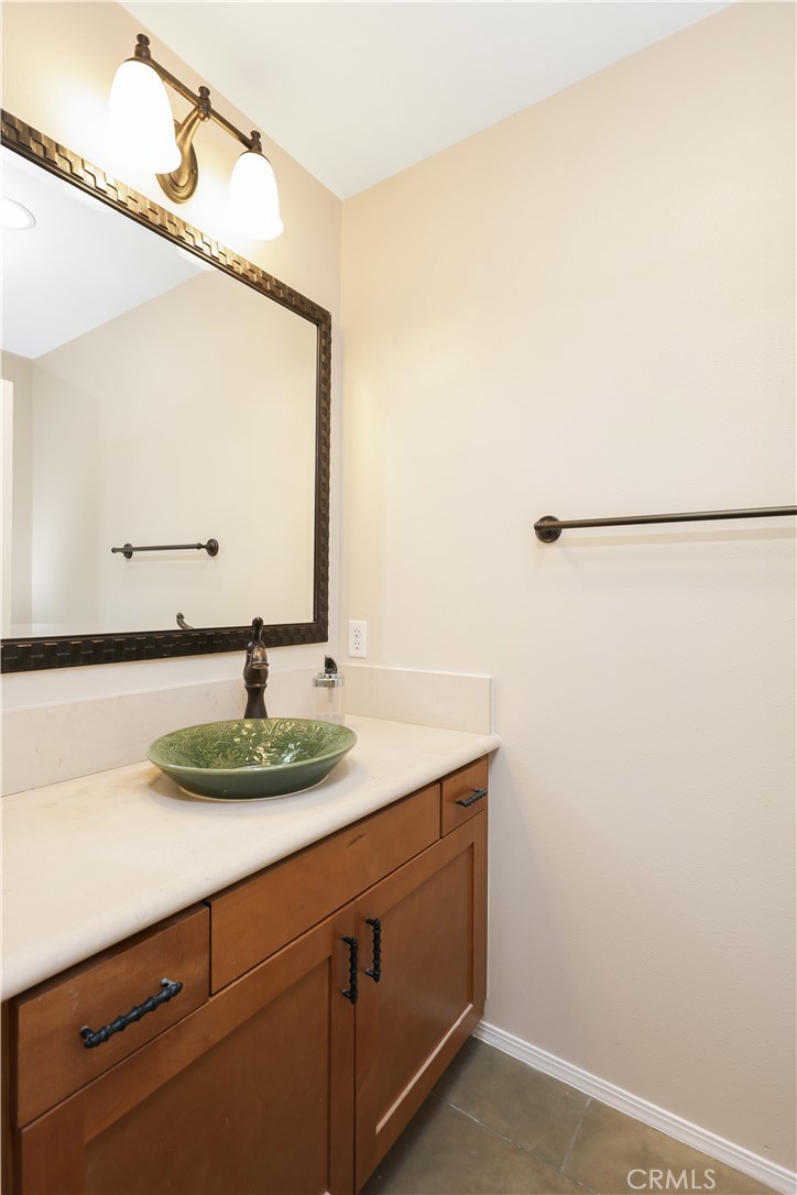 23 Crosspointe Irvine, CA 92618 - Photo 10 of 47 a bathroom with a granite countertop sink and a mirror