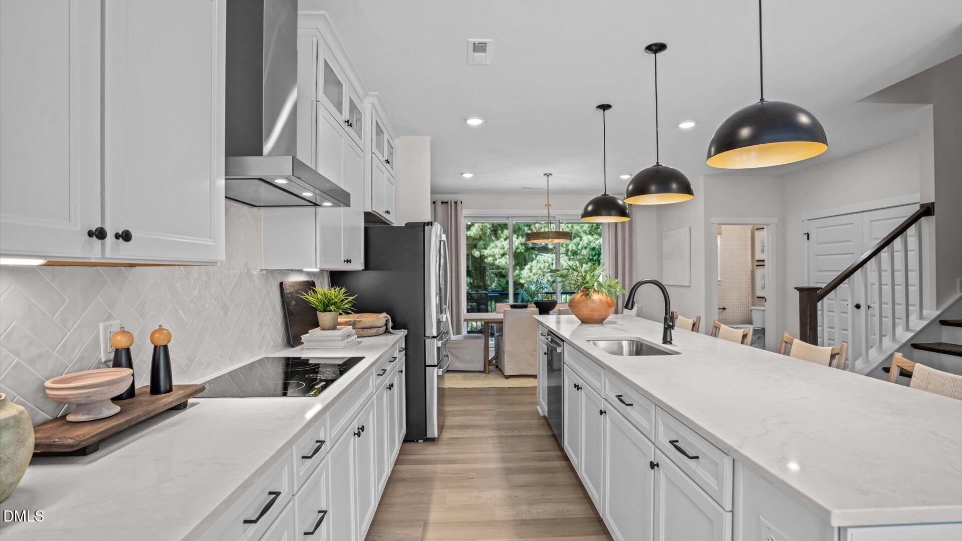 6108 Dunzo Drive Raleigh, NC 27617 - Photo 7 of 32 a kitchen with stainless steel appliances a stove a sink a oven and a refrigerator