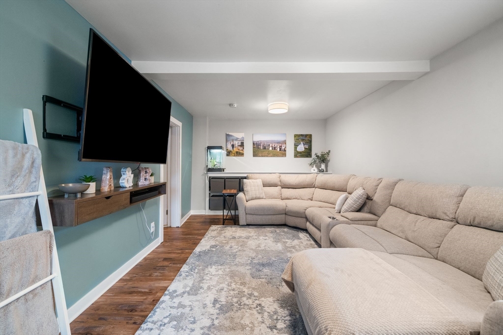 56 Ruggles Street Franklin, MA 02038 - Photo 17 of 42 a living room with furniture and a flat screen tv