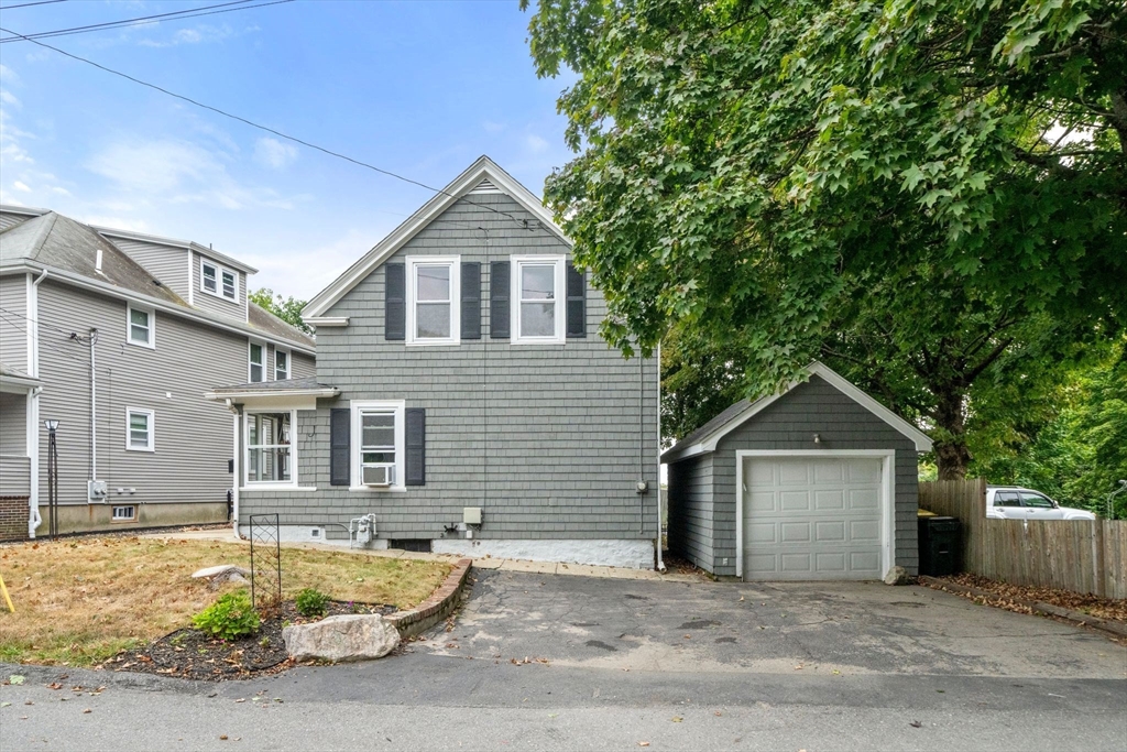 56 Ruggles Street Franklin, MA 02038 - Photo 3 of 42 a front view of a house with a yard and garage