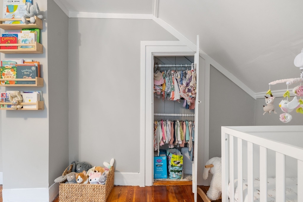56 Ruggles Street Franklin, MA 02038 - Photo 31 of 42 a bedroom with furniture and a book shelf
