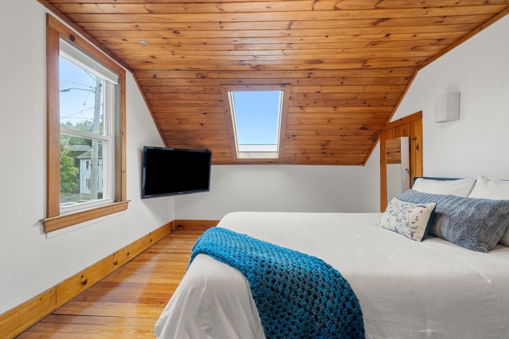 56 Ruggles Street Franklin, MA 02038 - Photo 33 of 42 a bedroom with a bed and a flat screen tv