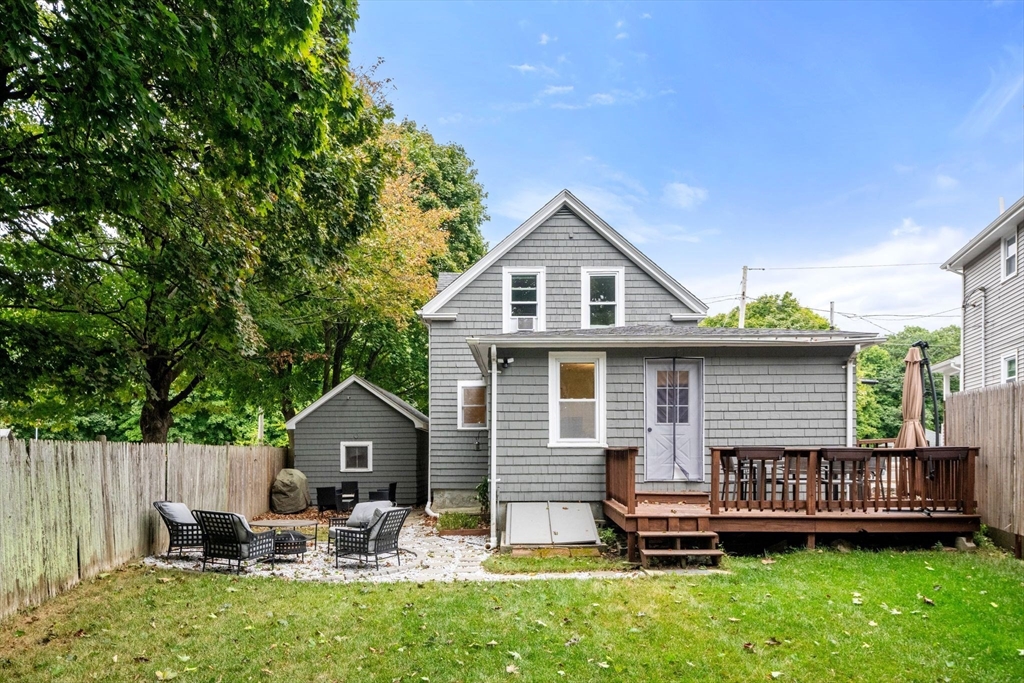 56 Ruggles Street Franklin, MA 02038 - Photo 35 of 42 a front view of a house with a garden and deck