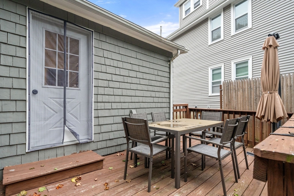 56 Ruggles Street Franklin, MA 02038 - Photo 37 of 42 a patio with table and chairs and potted plants