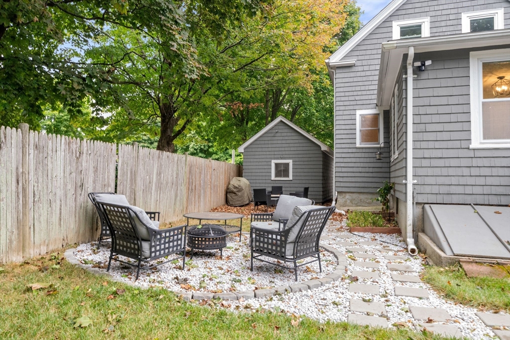 56 Ruggles Street Franklin, MA 02038 - Photo 40 of 42 a view of a chairs and table in backyard of the house