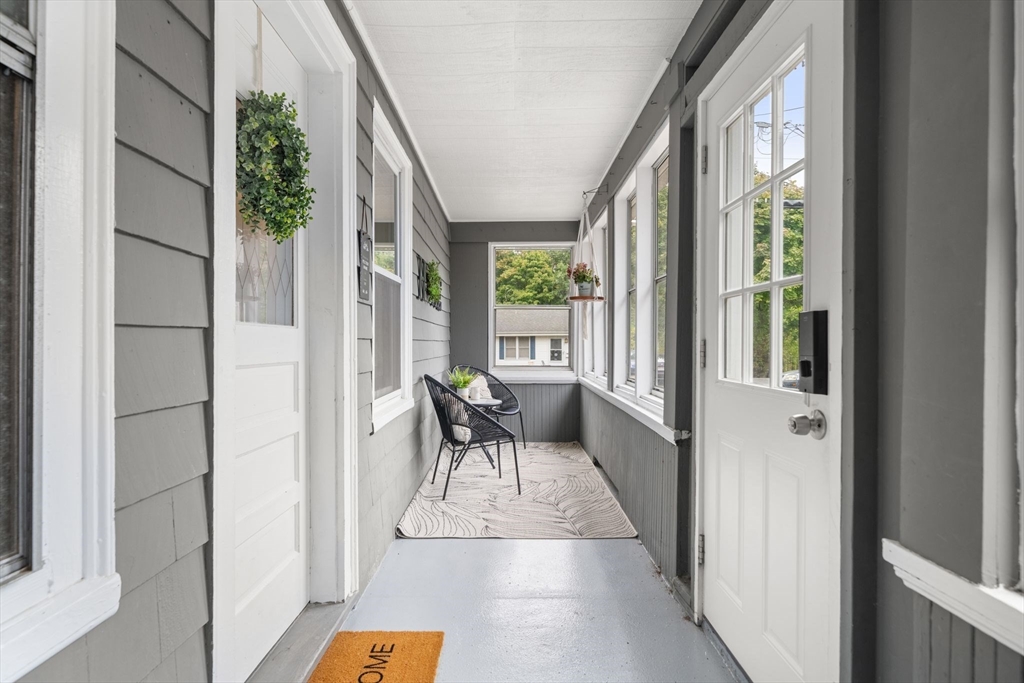 56 Ruggles Street Franklin, MA 02038 - Photo 4 of 42 a balcony with furniture and a potted plant