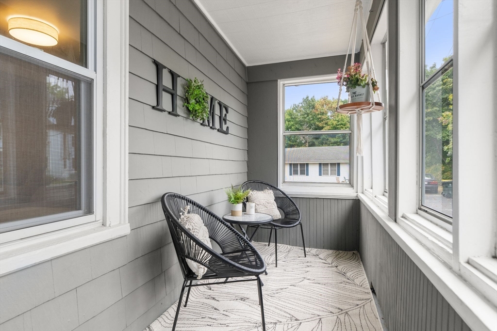 56 Ruggles Street Franklin, MA 02038 - Photo 5 of 42 a balcony with table and chairs