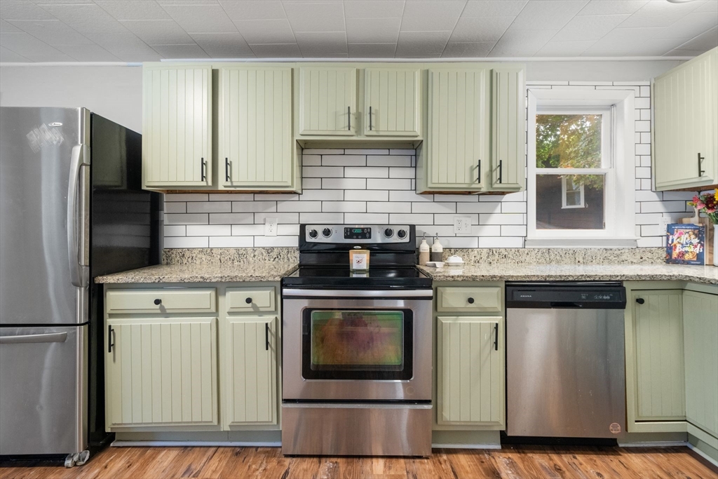 56 Ruggles Street Franklin, MA 02038 - Photo 7 of 42 a kitchen with stainless steel appliances granite countertop a stove a refrigerator and a sink