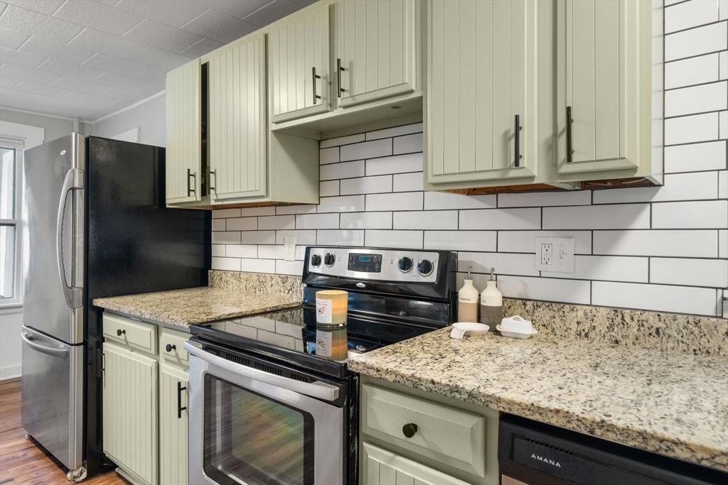56 Ruggles Street Franklin, MA 02038 - Photo 8 of 42 a kitchen with granite countertop cabinets stainless steel appliances and a sink