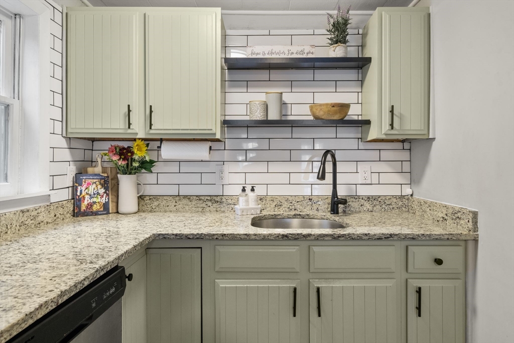 56 Ruggles Street Franklin, MA 02038 - Photo 9 of 42 a kitchen with granite countertop a sink a stove and cabinets