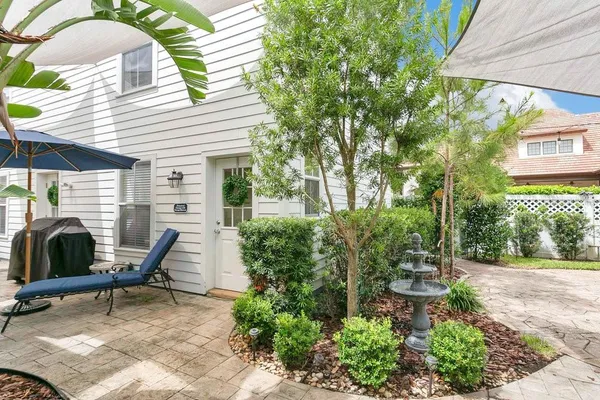 a view of a house with backyard porch and sitting area