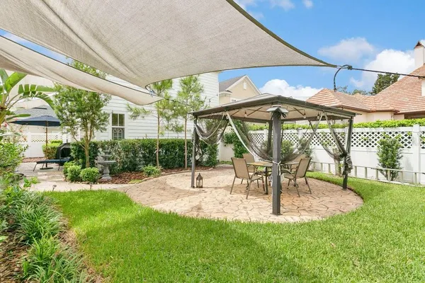 a view of a patio with a table and chairs under an umbrella