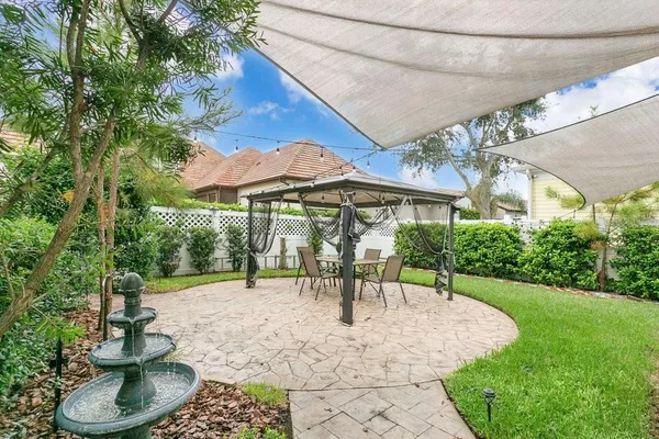 a view of a patio with a table and chairs under an umbrella