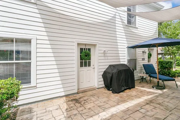 a view of a chair and fire pit in the backyard