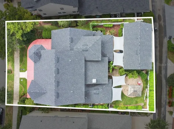 an aerial view of a house with a yard and lake view