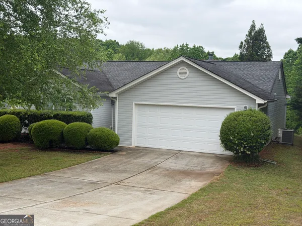 a view of a small house with a garage and a garage