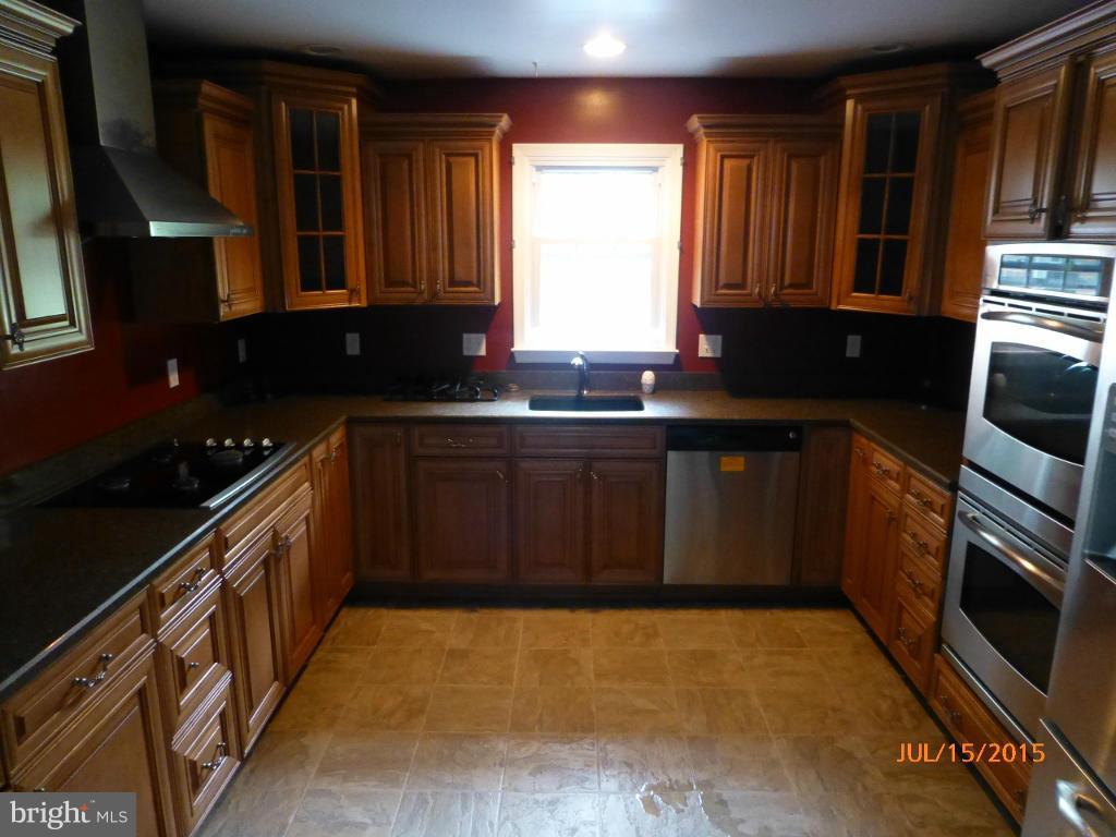 232 Bynum Ridge Road Forest Hill, MD 21050 - Photo 11 of 21 a kitchen with stainless steel appliances granite countertop a sink stove and cabinets