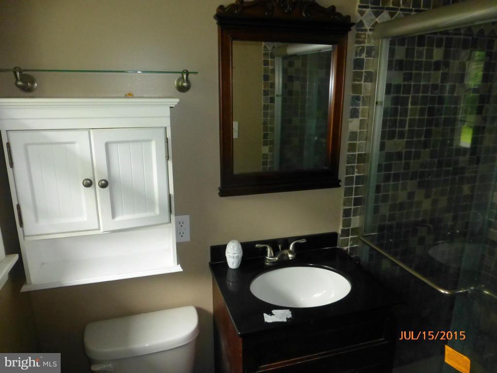 232 Bynum Ridge Road Forest Hill, MD 21050 - Photo 14 of 21 a bathroom with a toilet a sink and mirror