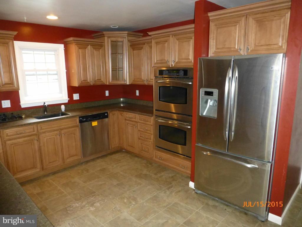 232 Bynum Ridge Road Forest Hill, MD 21050 - Photo 9 of 21 a kitchen with stainless steel appliances a refrigerator sink and cabinets