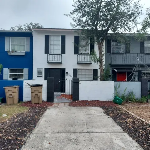 a view of a house with a yard and a garage