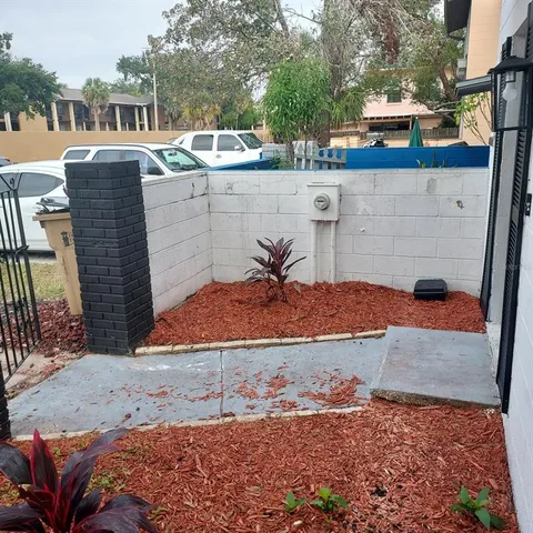 a view of a patio with a table and chairs