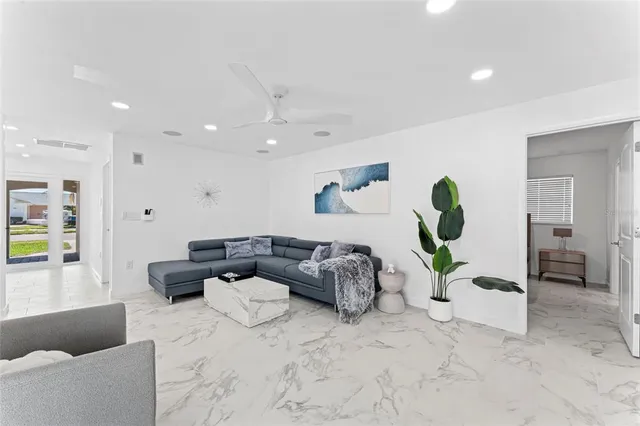 a living room with furniture and a potted plant