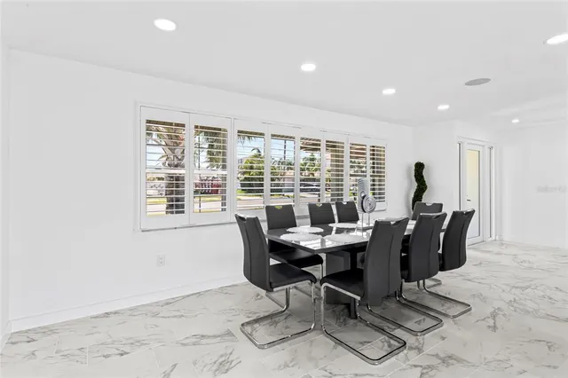 a view of a dining room with a table and chairs