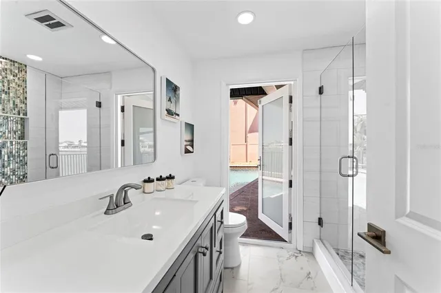 a en suite bathroom with a double vanity sink a mirror and a shower