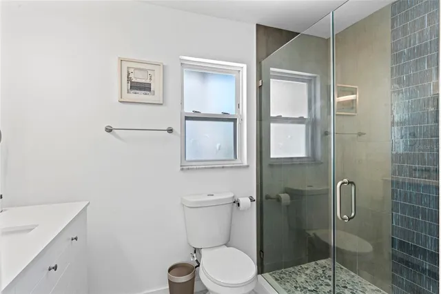 a bathroom with a toilet sink and shower