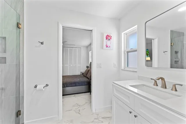 a en suite bathroom with a sink and a mirror