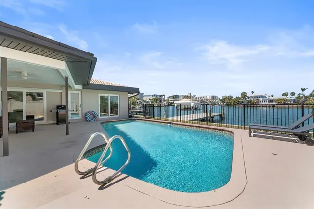 a view of a swimming pool with a lounge chair