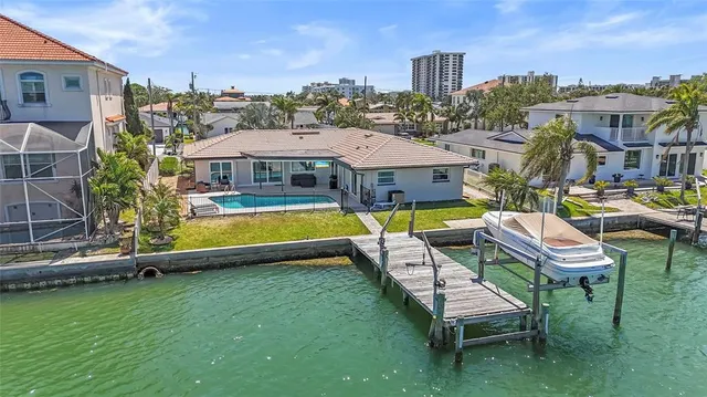 a view of a swimming pool with lounge chairs in patio