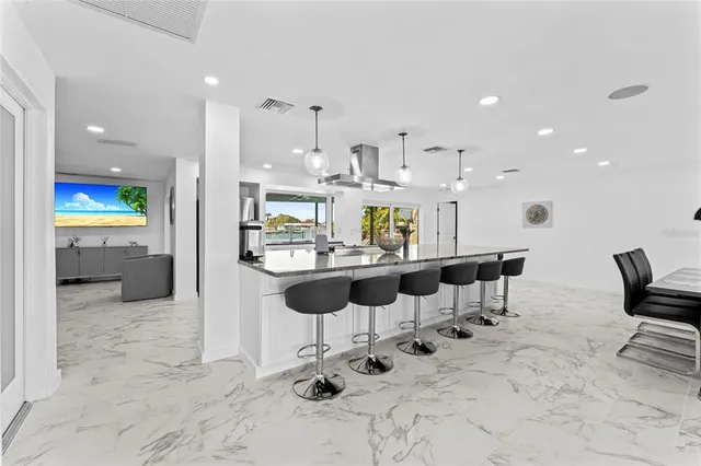 a kitchen with stainless steel appliances kitchen island granite countertop a sink and cabinets