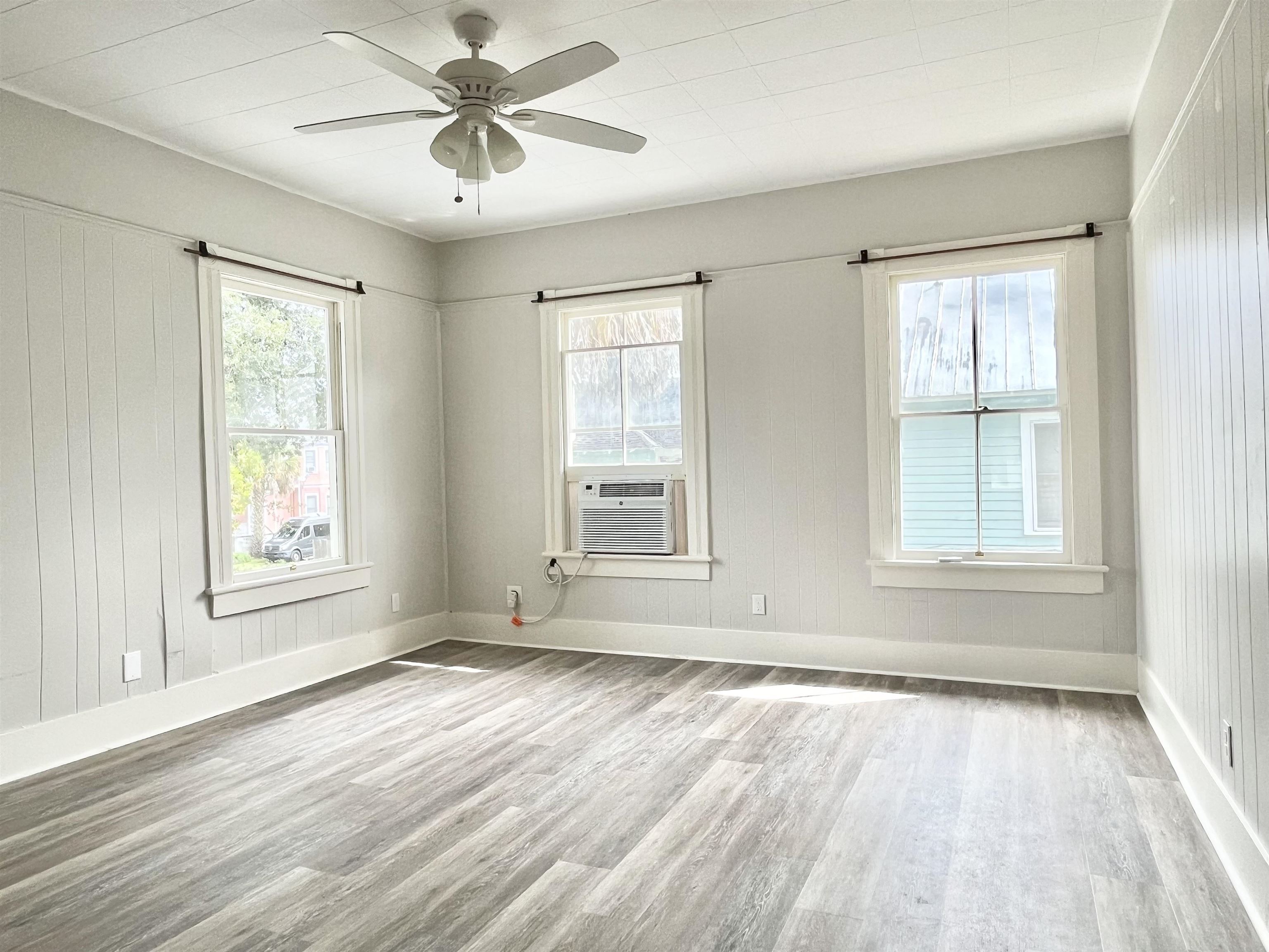 8 Rohde Avenue, Unit 4 St. Augustine, FL 32084 - Photo 13 of 18 a view of an empty room with a window and wooden floor
