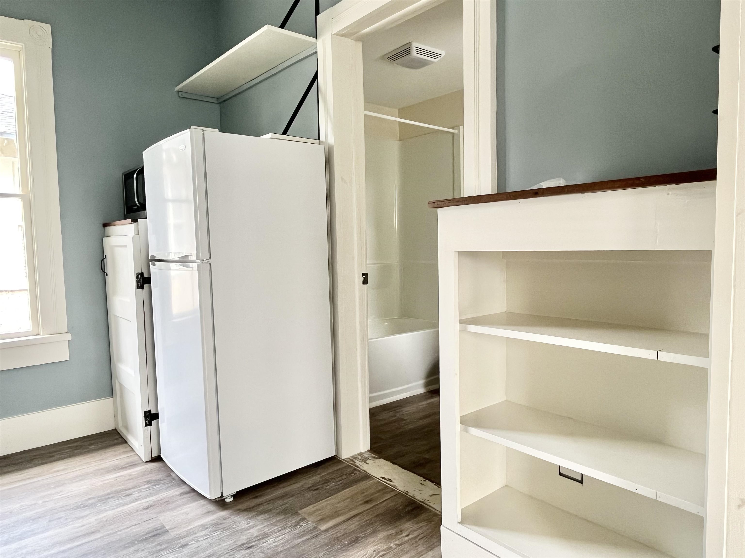 8 Rohde Avenue, Unit 4 St. Augustine, FL 32084 - Photo 18 of 18 a white refrigerator freezer and a wooden floor