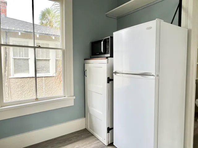 a white refrigerator freezer and a granite counter top