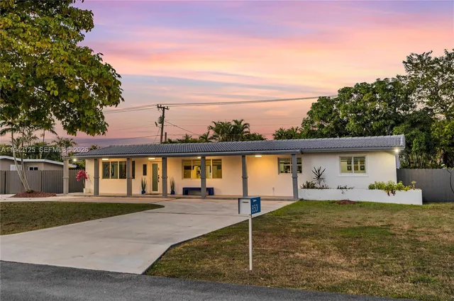 front view of a house with a tree