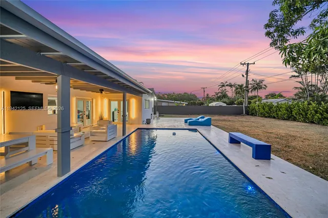 a view of an swimming pool with seating area