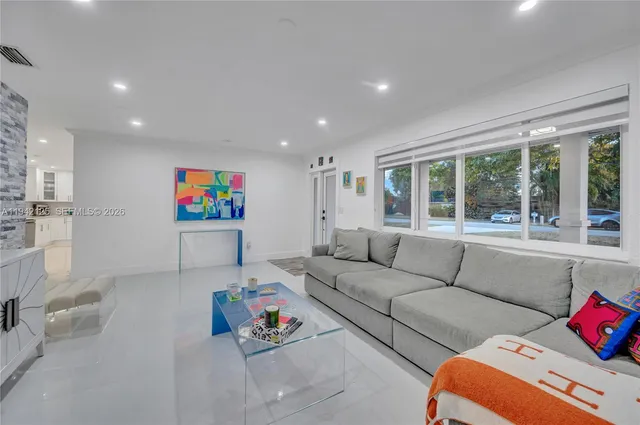 a kitchen with kitchen island a stove a table and chairs in it