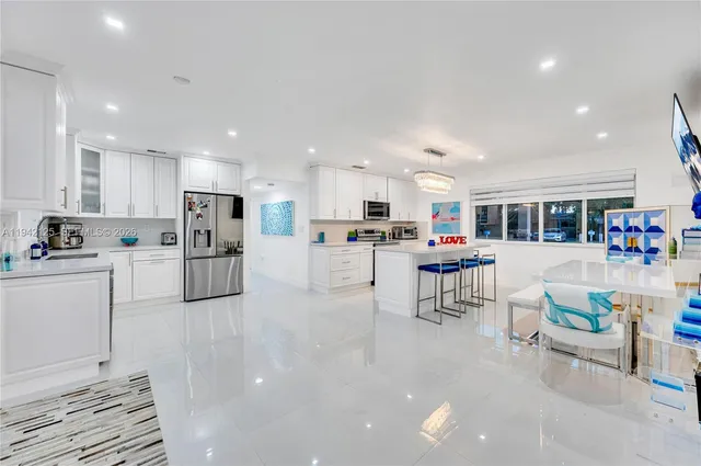 a kitchen that has a lot of cabinets and wooden floor