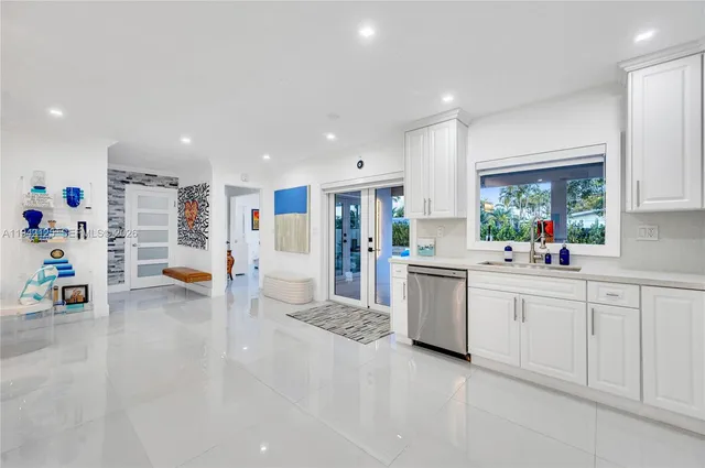 a kitchen with white cabinets and appliances