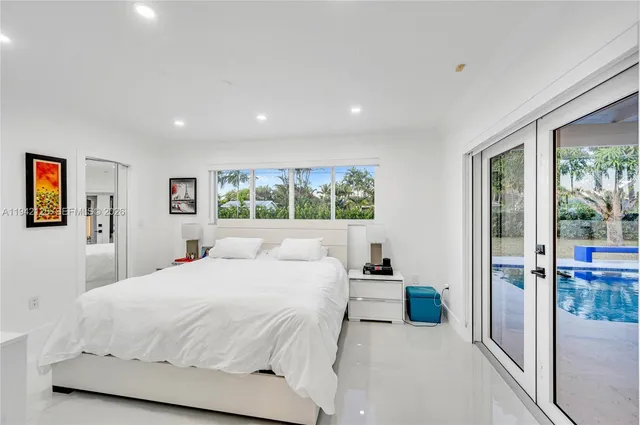 a bathroom with a bathtub sink mirror and shower