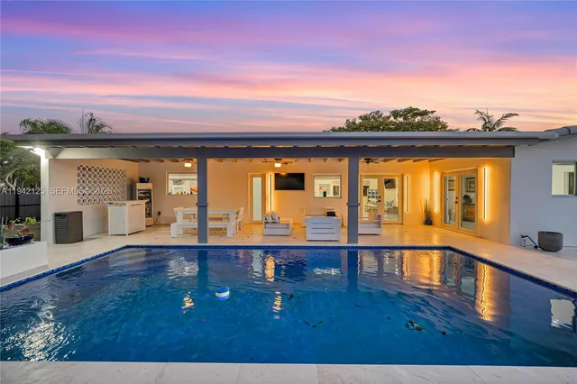 a view of a patio with table and chairs a barbeque with wooden floor and roof